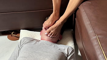Her Asian Soles Smother His Face, Forcing Him To Worship Her Feet As She Dominates Her Pathetic Husband.